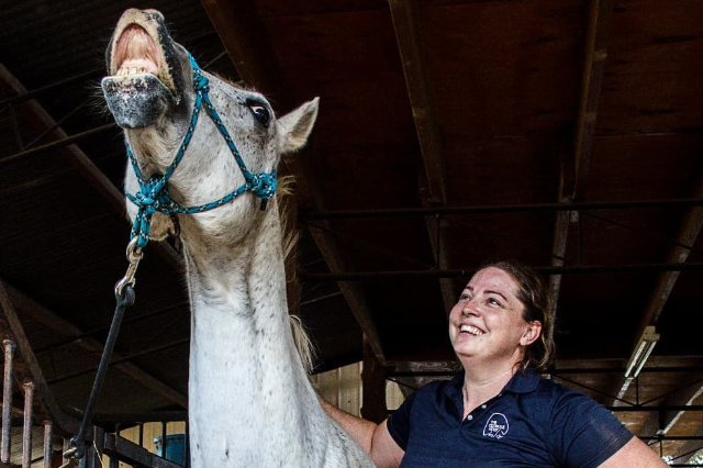 Lisa sharing a relaxed moment with a horse